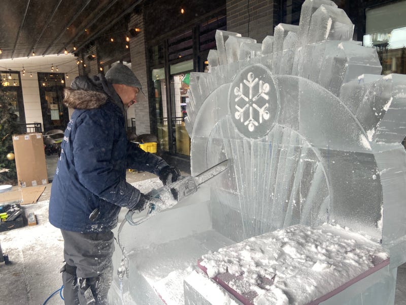 Sculptor John Njoes working on an ice throne on the new Grande Day Parade route along Grand Avenue in St. Paul.