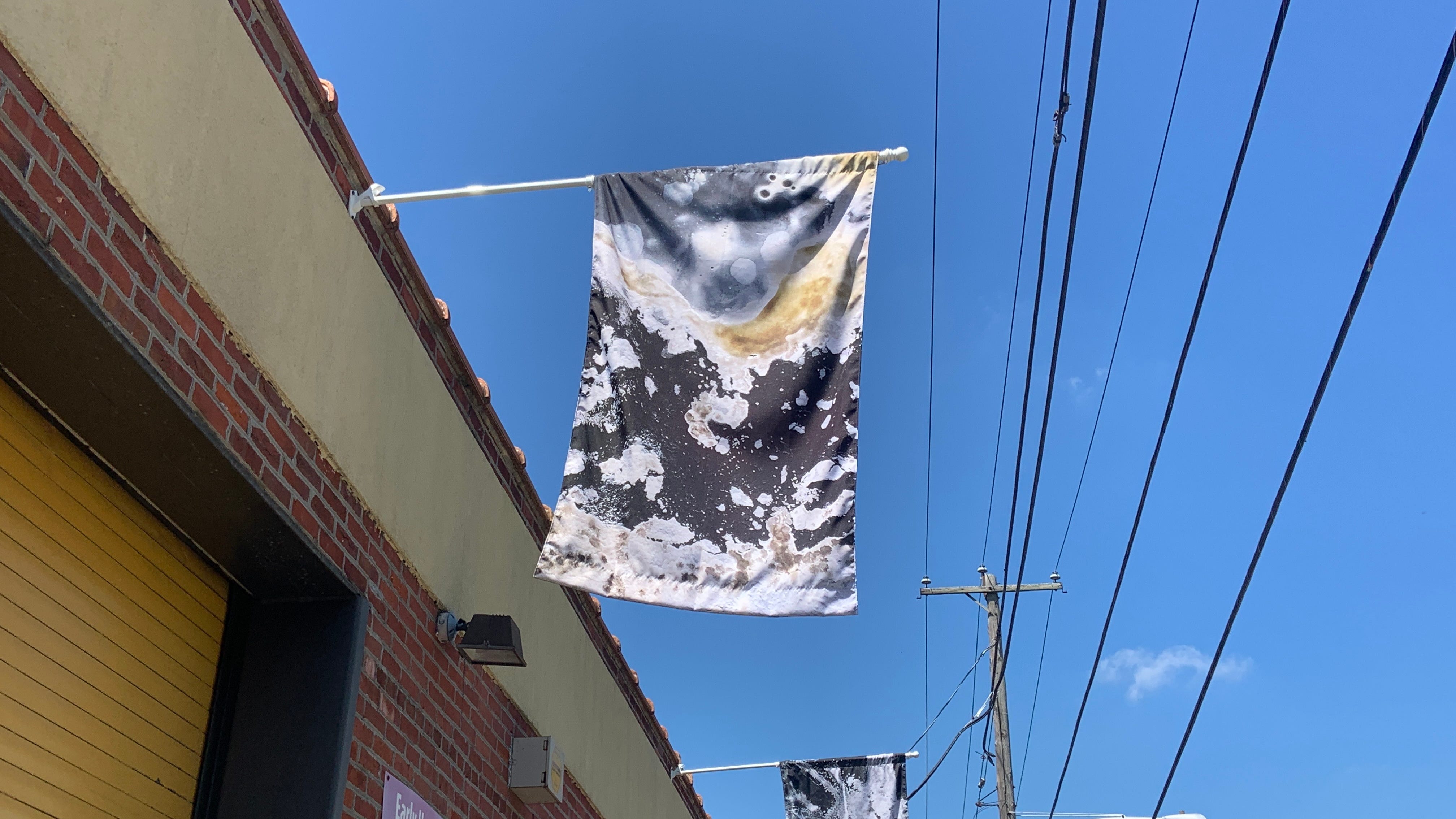 South Philly art series reflects on motherhood through breast milk banner display