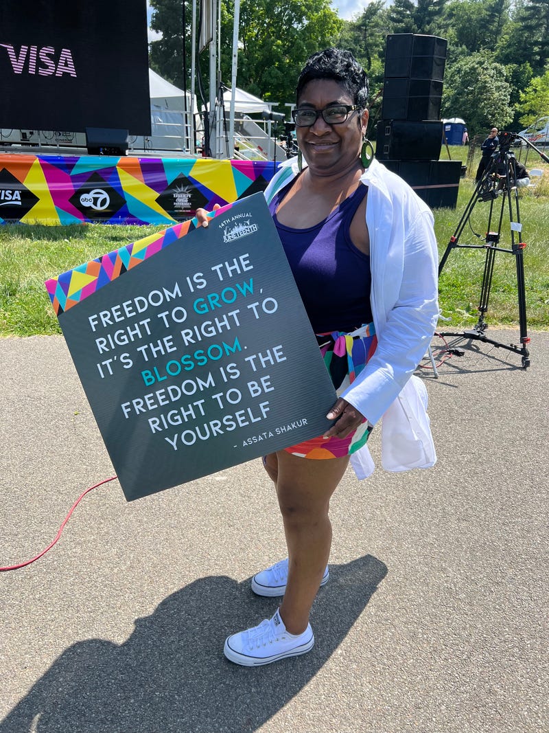 An attendee holds a sign at Sunday's concert and fashion show