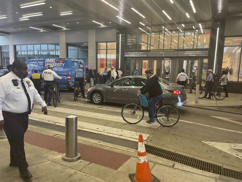 Police and security guards are prevalent at Fashion District entrances and exits.