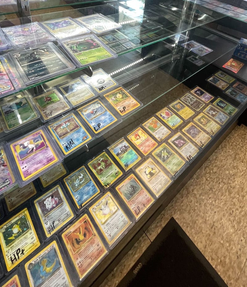 Pokemon cards behind a glass case at GreenLight Cards & Collectibles