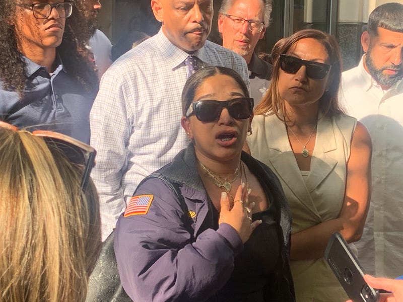 Marissa Fitzgerald (center), widow of Christopher Fitzgerald, speaks to the press after Miles Pfeffer's conviction on June 25, 2025.