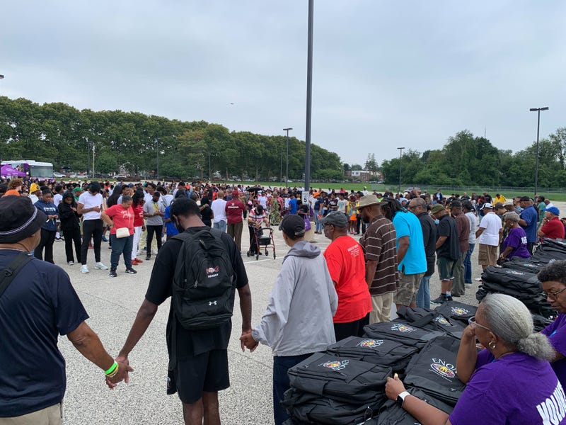 Prayer circle at Enon Tabernacle Baptist Church before a backpack giveaway on Saturday, Aug. 17, 2024.