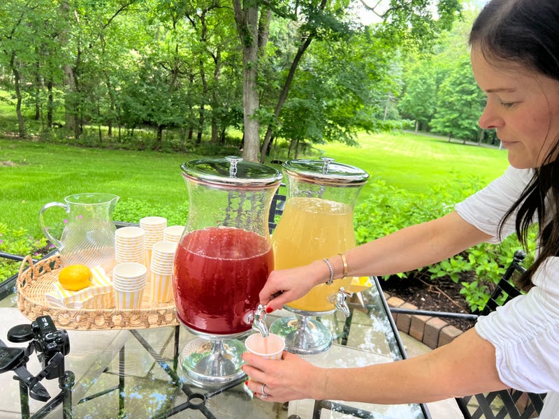 Danielle Moss works a lemonade stand as part of a fundraising effort for pediatric cancer research.