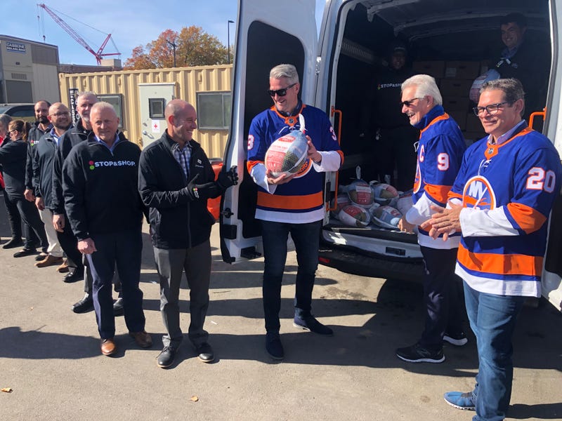 Islanders legends handle turkeys at today's event.