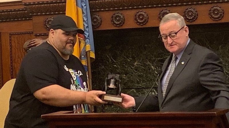 Mayor Jim Kenney awards Ryan Long with a model of the Liberty Bell for his achievements on "Jeopardy!"