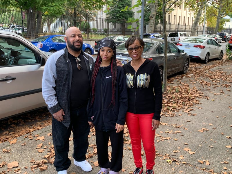 Tiara Dargan (center) reunites with her parents, Terrell Dargan (left) and Stephanie Jones (right), outside Girard College on Oct. 2, 2024. Tiara and about 30 other students were on a camping trip in North Carolina when Hurricane Helene came through and left them stranded for days.