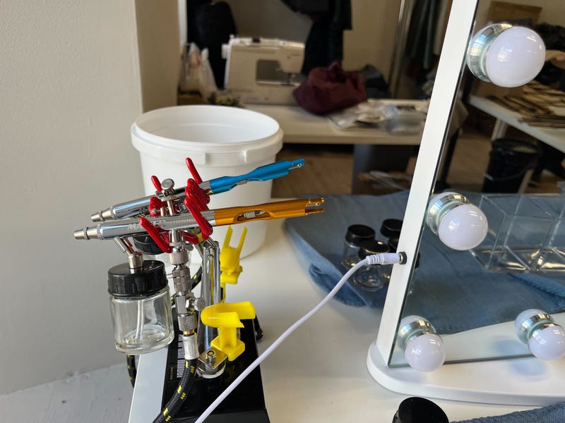 Airbrush makeup tools sit next to a mirror in the Lincoln Mill dressing room, waiting to gussy up scare actors.