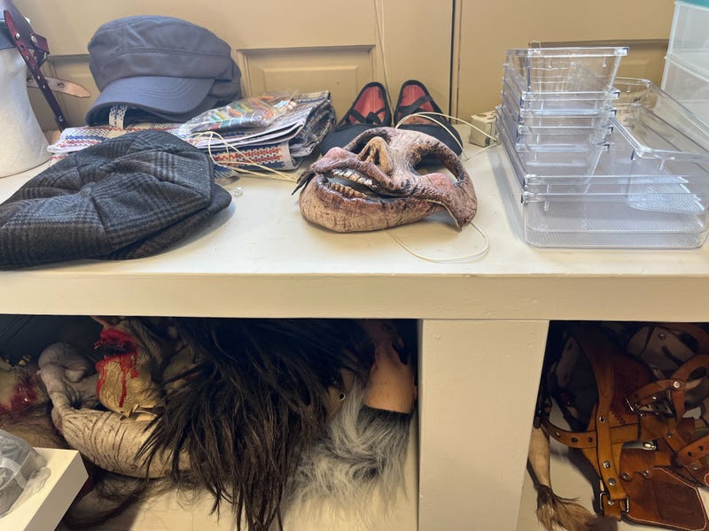 Masks, hats and wigs are strewn about in the Lincoln Mill dressing room.