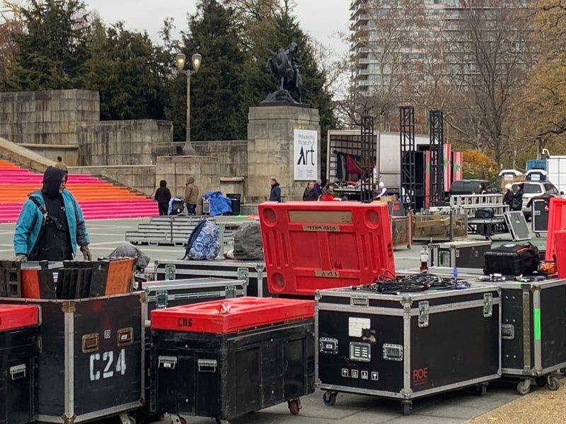 Workers unload and set up equipment for the 104th Thanksgiving Day Parade.