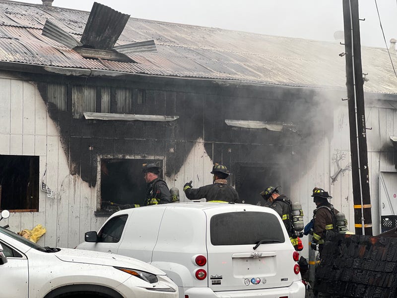 A fire destroyed a commercial building this morning in East Oakland, displacing people and animals.