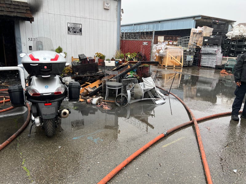 A fire destroyed a commercial building this morning in East Oakland, displacing people and animals.