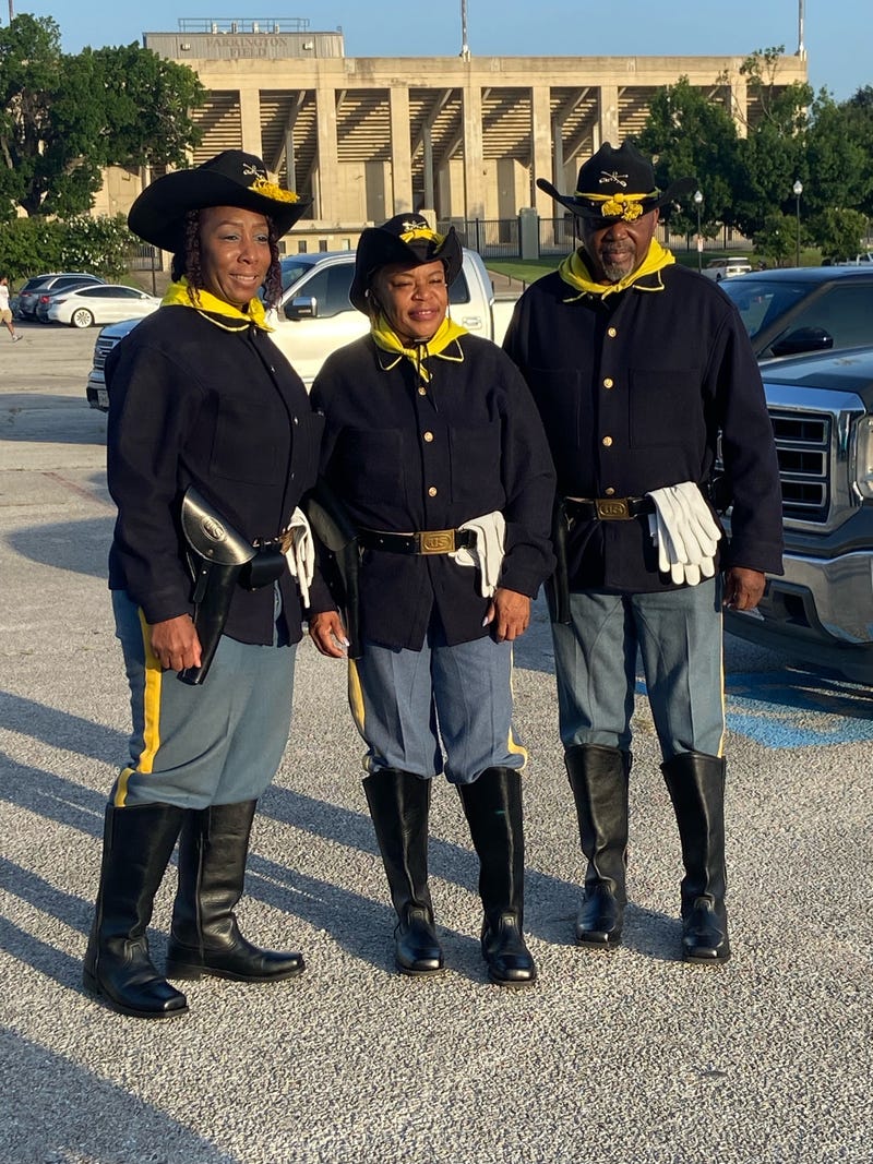 Dressed in tribute to the Buffalo Soldiers, participants in Fort Worth’s Juneteenth Freedom Walk pose outside Farrington Field — honoring the legacy of Black service members who fought for freedom long before it was fully granted.