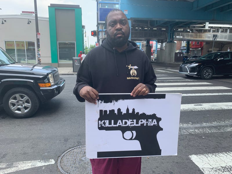 Oronde McCain protecting gun violence at 52nd and Market in West Philadelphia.
