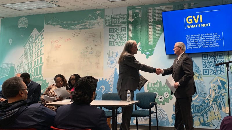 Mayor Jim Kenney greets David Kennedy, architect of Group Violence Intervention, who helped the city tailor its version of the program.