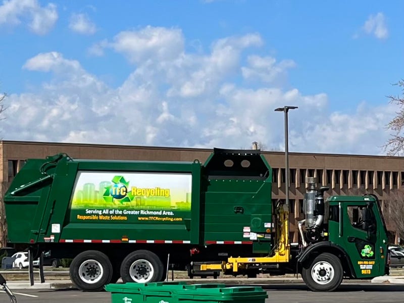 A parked recycling truck on a sunny day