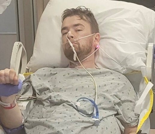 Colin Ledbetter is in a hospital gown hooked up to an IV
