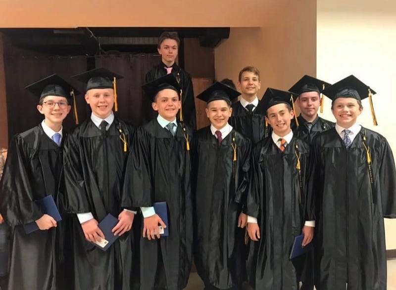 Michael Kennedy with his St. Hubert eighth grade class. Kennedy is leading an effort to save the school, which is set to close at the end of the school year due to declining enrollment. 