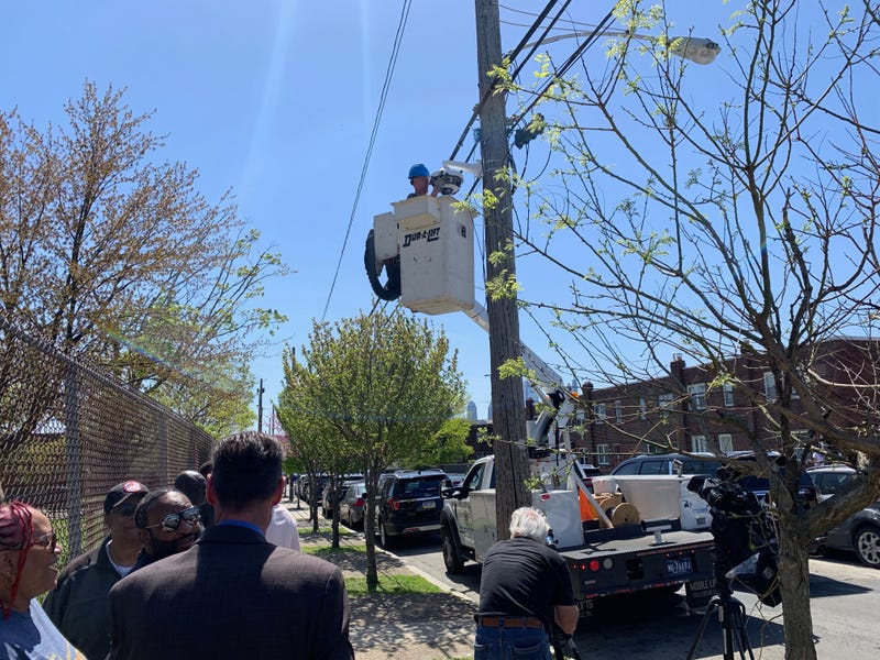 Workers install security cameras outside the perimeter of Dendy Recreation Center in North Philadelphia.