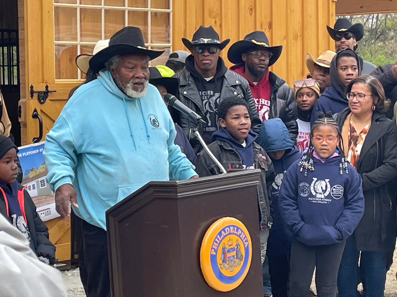 Ellis Ferrell Jr. surrounded by members of the Fletcher Street Urban Riding Club