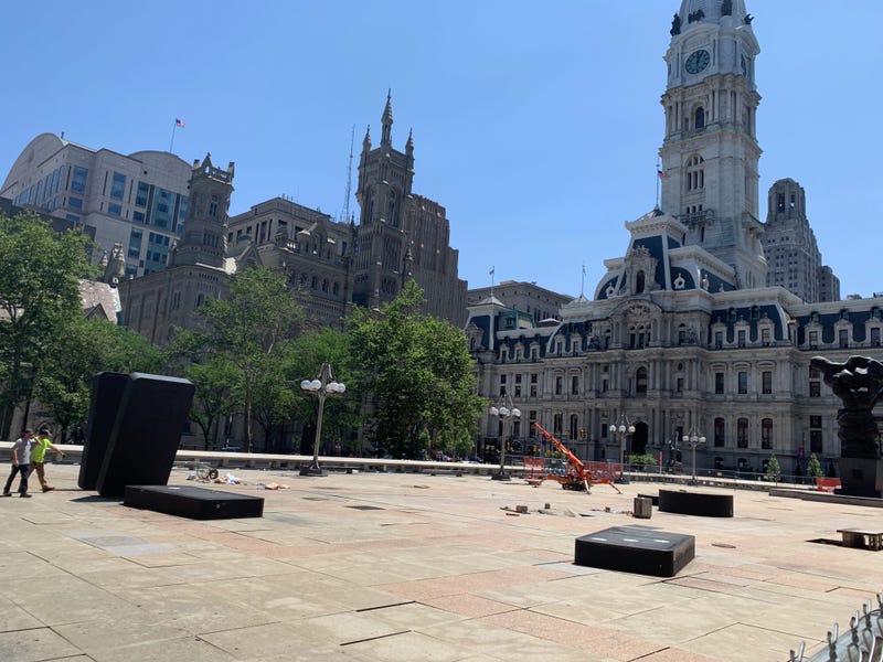 City workers remove the large decorative board game pieces that were a part of a public art exhibit in the plaza near Philadelphia City Hall