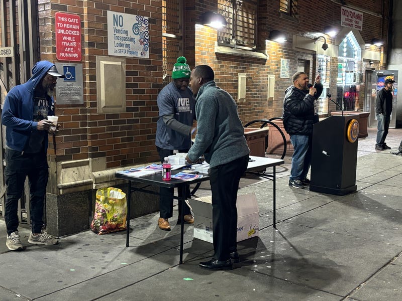 Philadelphia City Commissioner Omar Sabir (at podium) speaks at an event aimed at reaching morning commuters at the 52nd Street El station on Oct. 21, 2024.