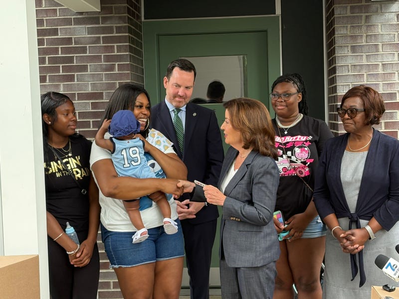 Governor Kathy Hochul giving the keys to the first residents of Perry Homes