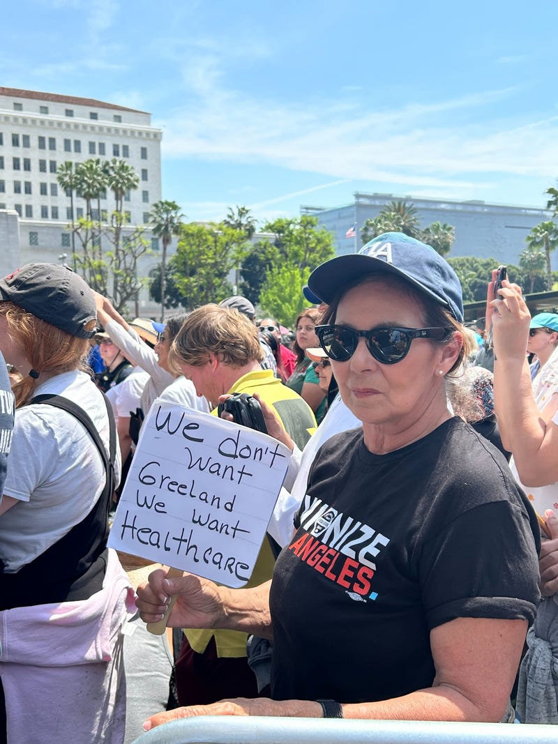 An attendee with a sign at the April 12, 2025 rally in Los Angeles. 