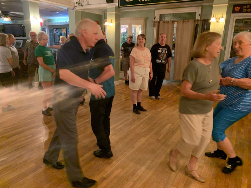 Dancers swing to the call of John Shields.