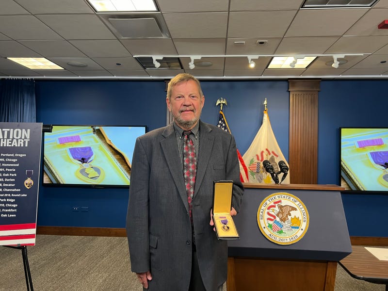 Jim Even holding Purple Heart