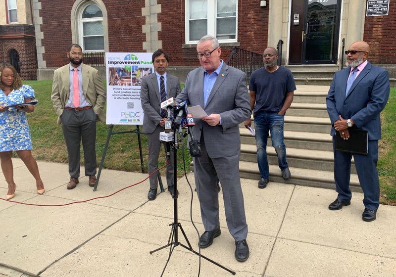 (back row, l to r.) City Councilmember Jamie Gauthier, state Rep. Rick Krajewski, landlord Steve Hawkins and PHDC CEO Dave Thomas look on as Mayor Jim Kenney discusses the Rental Improvement Fund.