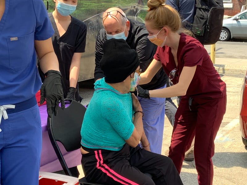Lawrence Carey, PharmD, Assistant Dean for Assessment & Quality and Clinical Professor of Pharmacy Practice at Temple University overseeing Doctor of Pharmacy student Liesel Groninger administering a COVID-19 shot at the Love Lot in Philadelphia's Kensington neighborhood.
