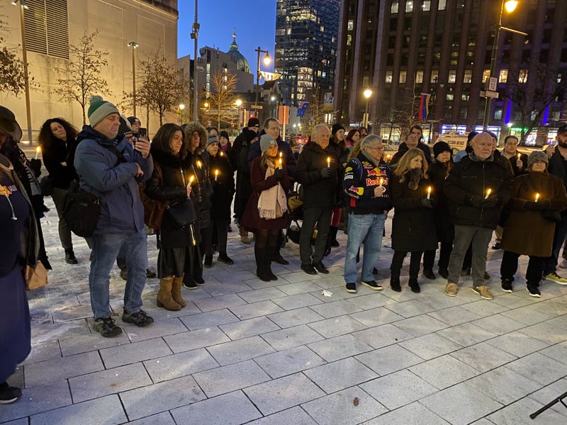 People gather a candle-lighting at the Horwitz-Wasserman Holocaust Memorial Plaza on Monday, Jan. 27, 2025.