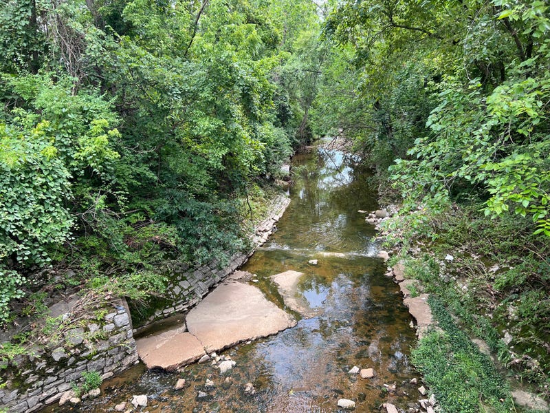 A section of the River Des Peres in University City bordered by rock walls and concrete.  