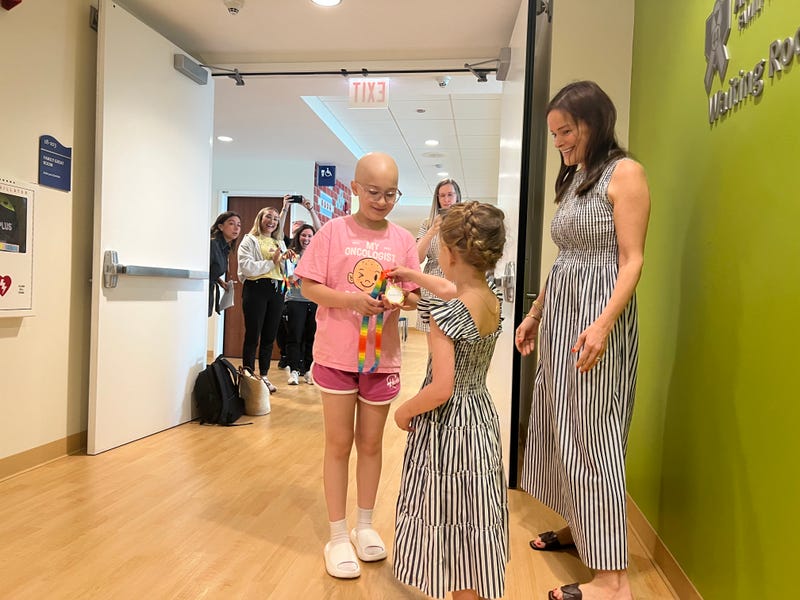 Olivia Wodzynski, 13, center, was among the pediatric cancer patients at Lurie Children's Hospital who received a medal during a ceremony on Tuesday.