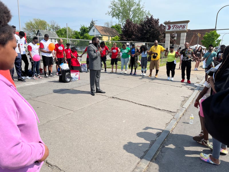 BUFFALO, N.Y. - People joining hands in prayer outside the fenced Tops.