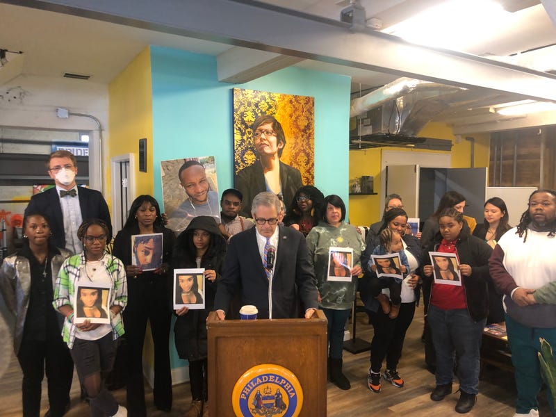 Friends and family hold pictures of transgender people who have been killed in Philadelphia