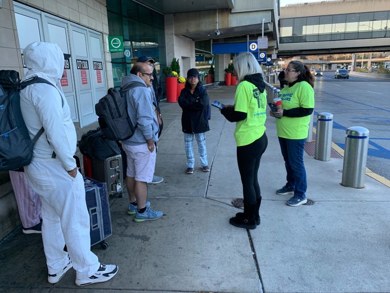 Union members at 20 airports nationwide, including Philadelphia International, distribute “end the shutdown” leaflets to travelers, highlighting shutdown-related safety concerns, on Oct. 28, 2025.