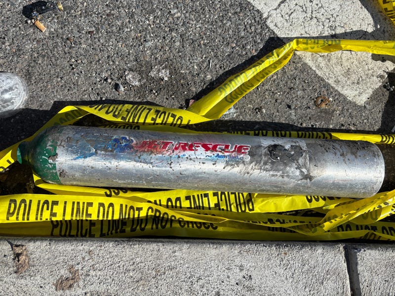 Police tape marks the location on Cottman Avenue where a tank from the plane landed.