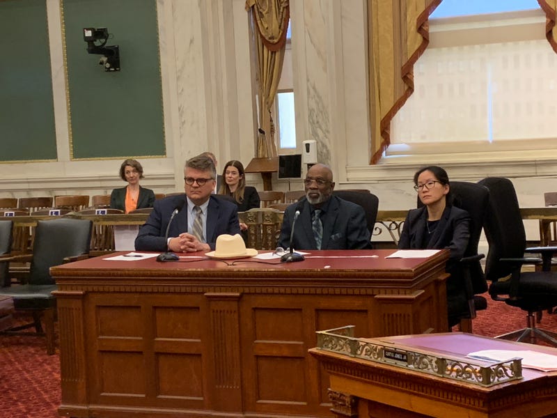 Timothy Calhoun (center), flanked by Michael Froehlich of Community Legal Services and Lucy Qui of Senior Law Center, fell victim to an MV Realty mortgage scam.