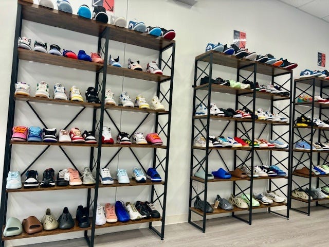 Racks of shoes show off the thrifting "sneaker culture" that has been built on the success of "Air Jordans". 
