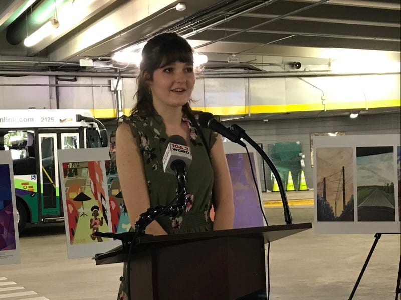 Kacy Lyvers, chair of Greenville City Youth Commission, speaks at ceremony for inaugural Bus Shelter Art Contest winners.