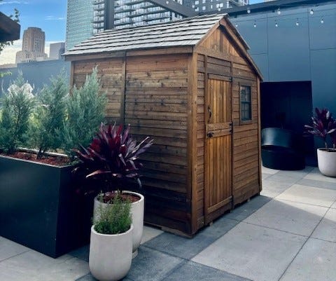 Setup is underway on the hotel's popular Nordic Village, with eight cozy, cedar cabins lining the outdoor terrace four floors up.