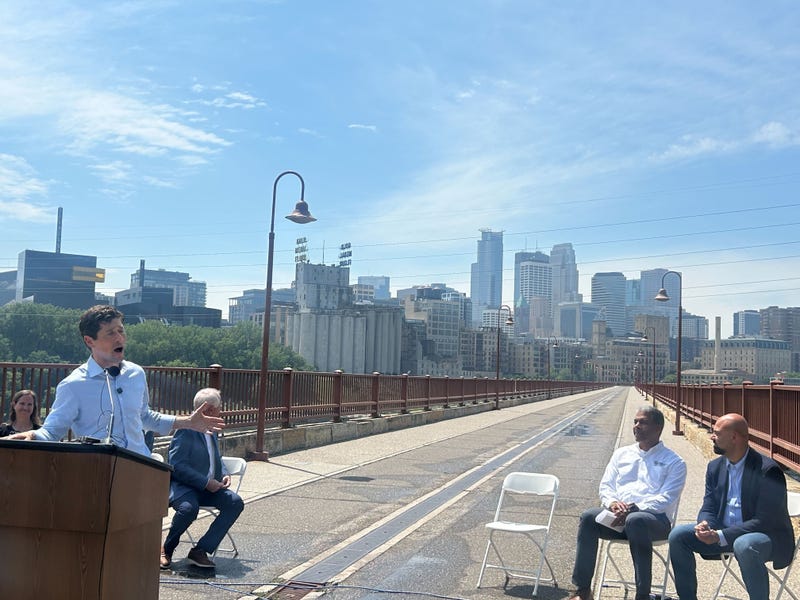 Minneapolis Mayor Jacob Frey (left standing) and Minnesota Governor Tim Walz (left seated) were among the officials announcing the reopening of Minneapolis' famous Stone Arch Bridge on Monday.