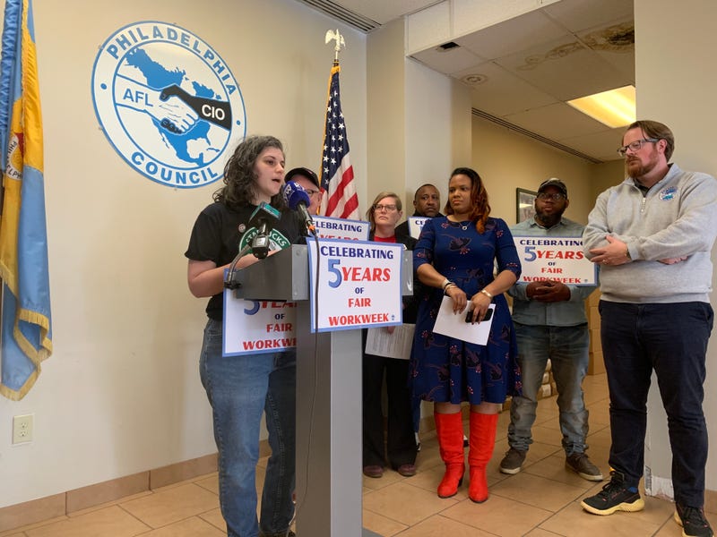 Sal Hirsch, a Starbucks barista, speaks at the podium to mark the fifth anniversary of Philadelphia's Fair Workweek Law, April 1, 2025.
