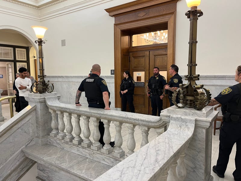 Sheriff’s deputies stand outside the courtroom after a family member lunged toward defendant Matthew Santiago during his sentencing on Aug. 22, 2024.