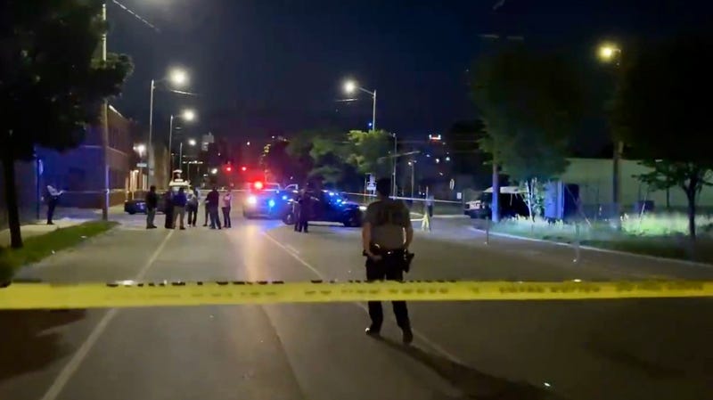 Officer walks towards active police scene in Corktown