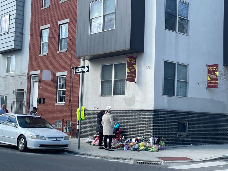 Strangers leave flowers and momentos at the makeshift memorial for Temple University police officer Christopher Fitzgerald, who was shot and killed Saturday night in the line of duty.