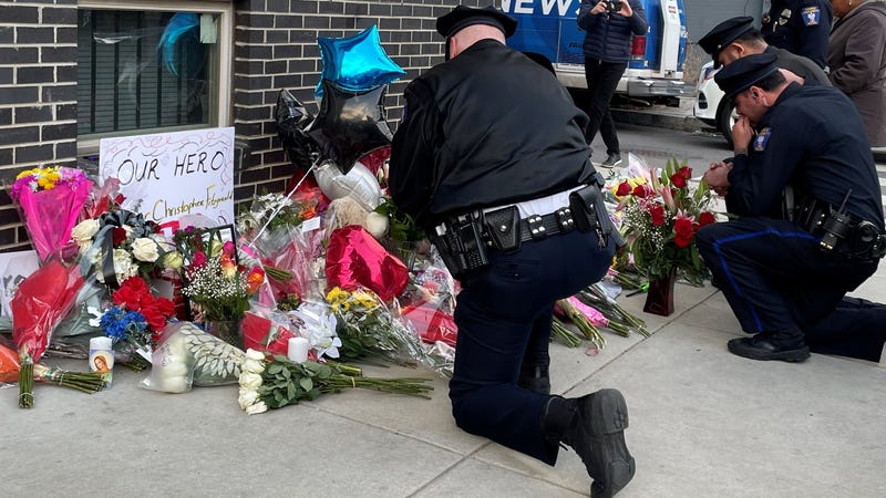 Police officers mourn at a makeshift memorial for Temple University police officer Christopher Fitzgerald, who was killed in the line of duty Saturday night near the campus.