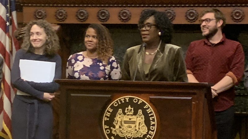 Deputy Mayor Sinceré Harris standing next to Mayor Cherelle Parker in City Hall.